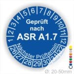 Prüfsiegel für ASR A1.7 mit nächstem Prüftermin, Durchmesser 20-50 mm, auf blauem Hintergrund.
