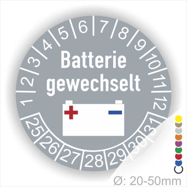 Prüfaufkleber, Prüfplakette rund, Farbe- Grau, Text "Batterie gewechselt" in Weiss. Icon Batterie, Startjahr- 25, Monatszahlen Oben und Jahreszahlen Unten in Kreisform.