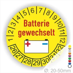 Prüfaufkleber, Prüfplakette rund, Farbe- Gelb, Text "Batterie gewechselt" in Rot. Icon Batterie, Startjahr- 26, Monatszahlen Oben und Jahreszahlen Unten in Kreisform.