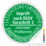 Grüne Prüfplakette nach DGUV Vorschrift 3, zeigt den nächsten Prüftermin an, Durchmesser 20-50 mm, nummeriert von 1 bis 12 und 1 bis 31 für die Monate und Tage.