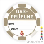 Alt-Text: Rundes Etikett für Gasprüfungen mit Platz für Name und Datum, gekennzeichnet durch ein Flammensymbol. Durchmesser von 30-50 mm, ideal für Sicherheitsanwendungen.