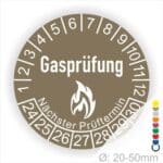 Prüfplaketten, Prüfetiketten rund, Farbe- Braun, Text "Gasprüfung" in Weiß danach eine Flamme als Pictogramm oder Icon in Weiß, Startjahr- 24, Monatszahlen Oben und Jahreszahlen Unten in Kreisform. Über den Jahreszahlen Text "Nächster Prüftermin"