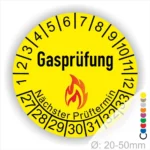 Gelbes Gasprüfungslabel mit dem Titel "Gasprüfung", das den nächsten Prüftermin anzeigt. 1 bis 12 und enthält Zahlen für die Monate sowie ein Flammensymbol. Durchmesser von 20 bis 50 mm.