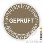 Prüfplakette rund, Farbe- Braun, Text "GEPRÜFT" in Weiß. Startjahr- 24, Monatszahlen Oben und Jahreszahlen Unten in Kreisform.