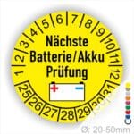 Batterie Akku Prüfung Prüfplaketten rund, Farbe- Gelb, Text "Nächste Batterie/Akku Prüfung" in Schwarz. Icon Batterie, Startjahr- 25, Monatszahlen Oben und Jahreszahlen Unten in Kreisform.
