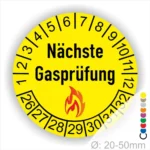 Runder Aufkleber in Gelb zur Kennzeichnung der nächsten Gasprüfung mit Feuer-Icon und Zahlen von 1 bis 12 Monatszahlen und 26-32 Jahreszahlen. Ideal für die Sicherheit von Gasinstallationen. Durchmesser 20-50 mm.