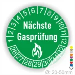 Runder Aufkleber in Gruen zur Kennzeichnung der nächsten Gasprüfung mit Feuer-Icon und Zahlen von 1 bis 12 Monatszahlen und 26-32 Jahreszahlen. Ideal für die Sicherheit von Gasinstallationen. Durchmesser 20-50 mm.