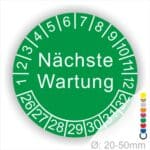 Prüfplaketten, Prüfetiketten rund, Farbe- Grün, Text "Nächste Wartung" in Weiß. Startjahr- 26, Monatszahlen Oben und Jahreszahlen Unten in Kreisform.