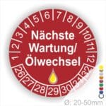 Prüfetiketten, Prüfaukleber rund, Farbe- Rot, Text "Nächste Wartung/Ölwechsel" in Weiß. Startjahr- 26, Monatszahlen Oben und Jahreszahlen Unten in Kreisform, über den Jahreszahlen ein Öltropfen als Icon/Piktogramm in Gelb.