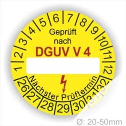 Prüfplakette rund mit Text geprüft nach DGUV Vorschrift 4 danach Beschriftungsfeld in Weiß und Text Nächster Prüftermin. Plaketten Farbe- Gelb und Text in Schwarz. Monatszahlen oben und Jahreszahlen unten beginnend mit Startjahr- 26.