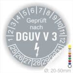 Prüfplakette rund mit Text geprüft nach DGUV V 3 danach Elektropfeil und Text Nächster Prüftermin. Plaketten Farbe- Grau und Text in Weiß. Monatszahlen oben und Jahreszahlen unten beginnend mit Startjahr- 25. Durchmesser 20-50mm frei wählbar.