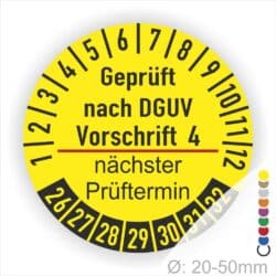 Prüfplakette mit Text Geprüft nach Dguv Vorschrift 4 und Nächster Prüftermin mit zwischen Strich in Rot. Plaketten Farbe- Gelb und Text in Schwarz. Monatszahlen oben und Jahreszahlen unten beginnend mit Startjahr- 26