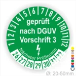 Grünes Prüfzeichen nach DGUV Vorschrift 3, das Informationen über den nächsten Prüftermin und die Prüfnorm für Geräte mit einem Durchmesser von 20-50 mm anzeigt.