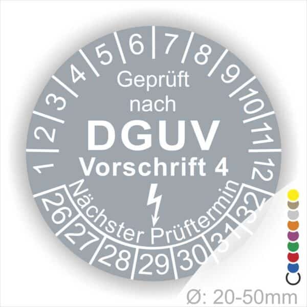 Prüfplakette rund mit Text geprüft nach Dguv Vorschrift 3 danach Elektropfeilund Text Nächster Prüftermin. Plaketten Farbe- Grau und Text in Weiß. Monatszahlen oben und Jahreszahlen unten beginnend mit Startjahr- 26.