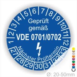 Prüfsiegel für elektrische Geräte gemäß VDE 0701/0702, blaues Design mit Angabe des nächsten Prüftermins und Durchmesser von 20-50 mm.