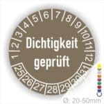 Prüfetiketten, Prüfaukleber rund, Farbe- Braun, Text auf Englisch "Dichtigkeit geprüft" in Weiß. Startjahr- 25, Monatszahlen Oben und Jahreszahlen Unten in Kreisform.