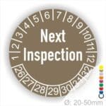 Prüfplaketten, Prüfetiketten rund, Farbe- Braun, Text auf Englisch "Next Inspection" in Weiß. Startjahr- 26, Monatszahlen Oben und Jahreszahlen Unten in Kreisform.