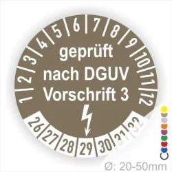 Runde Prüfplakette mit der Aufschrift "geprüft nach DGUV Vorschrift 3", geeignet für Geräte mit einem Durchmesser von 20-50 mm, zeigt Prüfintervalle von 1 bis 12 Monaten sowie die Kennzeichnung für elektrische Sicherheit.