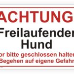Achtungsschild für freilaufende Hunde mit Warnhinweis, dass die Tore geschlossen bleiben müssen und das Betreten auf eigene Gefahr erfolgt.
