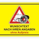 Warnschild mit Überwachungskamera und dem Text "WUNSCHTEXT NACH IHREN ANGABEN ohne Aufpreis" auf gelbem Hintergrund.