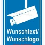 Schild mit Überwachungskamera und Platz für Wunschtext oder Wunschlogo, auf blauem Hintergrund. Ideal für Sicherheits- und Überwachungszwecke.