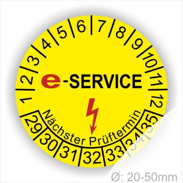 Prüfplaketten rund, Farbe- Gelb, Text "E-SERVICE" in Schwarz danach ein Elektro- Pfeil in Rot, Startjahr- 29, Monatszahlen Oben und Jahreszahlen Unten in Kreisform. Über den Jahreszahlen Text "Nächster Prüftermin"