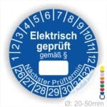Pruefplakette mit Text Elektrisch geprüft gemäß Paragrapf als Zeichen und Beschriftungfeld zum eintragen des Paragraphs Farbe- Blau Startjahr- 26 mit Monatszahlen Oben und Jahreszahlen Unten Form ist Rund