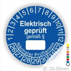 Pruefplakette mit Text Elektrisch geprüft gemäß Paragrapf als Zeichen und Beschriftungfeld zum eintragen des Paragraphs Farbe- Blau Startjahr- 26 mit Monatszahlen Oben und Jahreszahlen Unten Form ist Rund