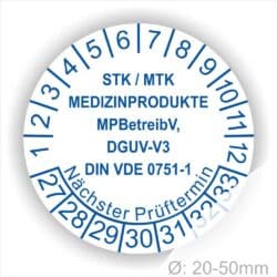 Prüfplaketten, Prüfetiketten rund, Farbe- Weiß, Text "STK/MTK MEDIZINPRODUKTE MPBetreibV, DGUV-V3, DIN VDE 0751-1 Nächster Prüftermin" in Blau. Startjahr- 27, Monatszahlen Oben und Jahreszahlen Unten in Kreisform. über den Jahreszahlen Text.