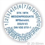 Prüfplaketten, Prüfetiketten rund, Farbe- Weiß, Text "STK/MTK MEDIZINPRODUKTE MPBetreibV, DGUV-V3, DIN VDE 0751-1 Nächster Prüftermin" in Blau. Startjahr- 29, Monatszahlen Oben und Jahreszahlen Unten in Kreisform. über den Jahreszahlen Text.