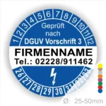 Alt-Text: Prüfplakette mit dem Hinweis "Geprüft nach DGUV Vorschrift 3", Platz für Firmennamen und Telefonnummer, mit farbigen Markierungen zur Kennzeichnung, Durchmesser von 25-50mm.
