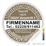 Alt-Text: Prüfplakette gemäß DGUV Vorschrift 3 mit Firmennamen, Telefonnummer, Adresse und nächstem Prüftermin, Durchmesser 25-50 mm.