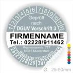 Bild eines Prüfaufklebers, der nach DGUV Vorschrift 3 zertifiziert ist. Enthält Informationen wie Firmenname, Telefonnummer, Adresse und den nächsten Prüftermin. Der Aufkleber hat einen Durchmesser von 25-50 mm und zeigt farbige Markierungen.