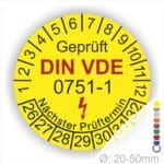 Prüfplaketten rund, Farbe- Gelb, Text "Geprüft gemäß DIN VDE 0751-1" in Schwarz danach ein Elektro- Pfeil in Rot, Startjahr- 26, Monatszahlen Oben und Jahreszahlen Unten in Kreisform. Über den Jahreszahlen Text "Nächster Prüftermin"