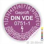 Prüfplaketten rund, Farbe- Lila, Text "Geprüft gemäß DIN VDE 0751-1" in Weiß danach ein Elektro- Pfeil in Weiß, Startjahr- 26, Monatszahlen Oben und Jahreszahlen Unten in Kreisform. Über den Jahreszahlen Text "Nächster Prüftermin"