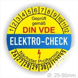 Prüfetiketten, Prüfplaketten rund, Farbe- Gelb in der Mitte ein Streifen in Blau, Text oberer Teil "Geprüft gemäß DIN-VDE" in Schwarz. Mittig Streifen in Rot mit dem Text " ELEKTRO-CHECK", danach Elektropfeil in Rot Startjahr- 26, Monatszahlen Oben und Jahreszahlen Unten in Kreisform. Über den Jahreszahlen Text "Nächster Prüftermin"