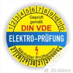 Prüfplaketten rund, Farbe- Gelb in der Mitte ein Streifen in Blau, Text oberer Teil "Geprüft gemäß DIN-VDE" in Schwarz. Mittig Streifen in Blau mit dem Text " ELEKTRO-PRÜFUNG", Danach Elektropfeil in Rot Startjahr- 27, Monatszahlen Oben und Jahreszahlen Unten in Kreisform. Über den Jahreszahlen Text "Nächster Prüftermin"