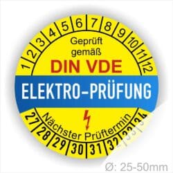 Prüfsiegel, Prüfplaketten rund, Farbe- Gelb in der Mitte ein Streifen in Blau, Text oberer Teil "Geprüft gemäß DIN-VDE" in Schwarz. Mittig Streifen in Blau mit dem Text " ELEKTRO-PRÜFUNG", Danach Elektropfeil in Rot Startjahr- 27, Monatszahlen Oben und Jahreszahlen Unten in Kreisform. Über den Jahreszahlen Text "Nächster Prüftermin"