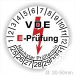 Prüfplaketten rund, Farbe- Weiß, Text "VDE E-Prüfung" in Schwarz in Hinergrund ein Elektro- Pfeil in Rot, Startjahr- 25, Monatszahlen Oben und Jahreszahlen Unten in Kreisform. Über den Jahreszahlen Text "Nächster Prüftermin"