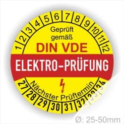 Prüfetiketten, Prüfplaketten rund, Farbe- Gelb in der Mitte ein Streifen in Rot, Text oberer Teil "Geprüft gemäß DIN-VDE" in Schwarz. Mittig Streifen in Rot mit dem Text " ELEKTRO-PRÜFUNG", danach Elektropfeil in Rot Startjahr- 27, Monatszahlen Oben und Jahreszahlen Unten in Kreisform. Über den Jahreszahlen Text "Nächster Prüftermin"