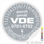 Prüfplaketten rund, Text "geprüft gemäß VDE 0701-0702" Farbe- Grau Startjahr- 25 mit Elektro Pfeil, Monatszahlen Oben und Jahreszahlen Unten