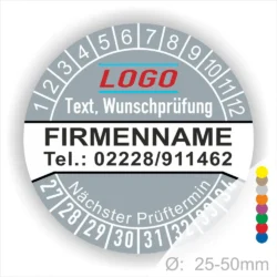 Graue Prüfplakette mit Monats- und Jahresring zur Kennzeichnung des nächsten Prüftermins, personalisierbar mit Firmenname, Logo, Telefonnummer und Wunschtext. Selbstklebender Prüfaufkleber für Wartung, Sicherheitsprüfung und Betriebsmittelkennzeichnung.