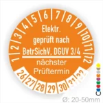 Elektrische Prüfplakette in Orange, die die Einhaltung der BetrSichV und DGUV 3/4 bestätigt, mit Angaben zum nächsten Prüftermin und einem Durchmesser von 20-50 mm.