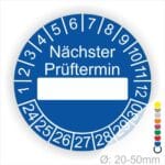 Prüfplakette, Prüfetikett rund, Farbe- Blau, Text "Nächster Prüftermin" in Weiß. Als nächstes kommt ein Beschriftungfeld / Leerfeld in Farbe Weiß. Startjahr- 24, Monatszahlen Oben und Jahreszahlen Unten in Kreisform.