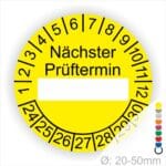 Prüfplakette, Prüfetikett rund, Farbe- Gelb, Text "Nächster Prüftermin" in Schwarz. Als nächstes kommt ein Beschriftungfeld / Leerfeld in Farbe Weiß. Startjahr- 24, Monatszahlen Oben und Jahreszahlen Unten in Kreisform.