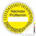 Prüfplakette, Prüfetikett rund, Farbe- Gelb, Text "Nächster Prüftermin" in Schwarz. Als nächstes kommt ein Beschriftungfeld / Leerfeld in Farbe Weiß. Startjahr- 26, Monatszahlen Oben und Jahreszahlen Unten in Kreisform.