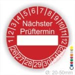 Prüfplakette, Prüfetikett rund, Farbe- Rot, Text "Nächster Prüftermin" in Weiß. Als nächstes kommt ein Beschriftungfeld / Leerfeld in Farbe Weiß. Startjahr- 26, Monatszahlen Oben und Jahreszahlen Unten in Kreisform.