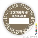 Prüfplakette, Prüfetikett rund, Farbe- Braun, Text "SICHTPRÜFUNG-BESTANDEN" in Weiß. Als nächstes kommt ein Beschriftungfeld / Leerfeld in Farbe Weiß. Startjahr- 24, Monatszahlen Oben und Jahreszahlen Unten in Kreisform.