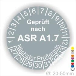 Prüfplaketten, Prüfetiketten rund, Farbe- Grau, Text "Geprüft nach ASR A1.7" in Weiß. Startjahr- 27, Monatszahlen Oben und Jahreszahlen Unten in Kreisform über den Jahreszahlen Text "Nächster Prüftermin".