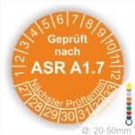 Prüfplaketten, Prüfetiketten rund, Farbe- Orange, Text "Geprüft nach ASR A1.7" in Weiß. Startjahr- 27, Monatszahlen Oben und Jahreszahlen Unten in Kreisform über den Jahreszahlen Text "Nächster Prüftermin".